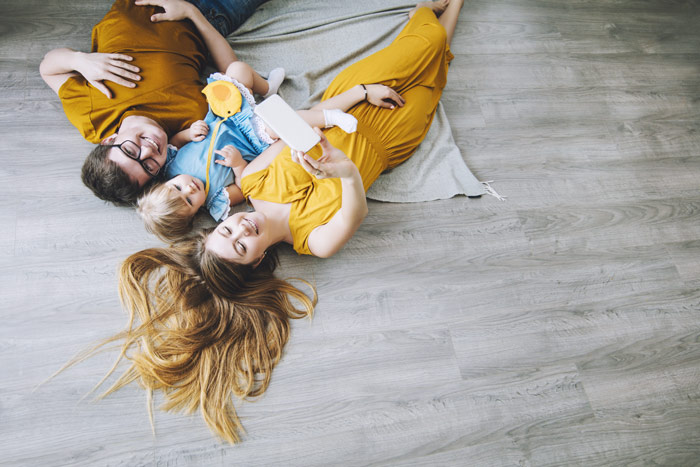 kids varying in age laying on wood floor